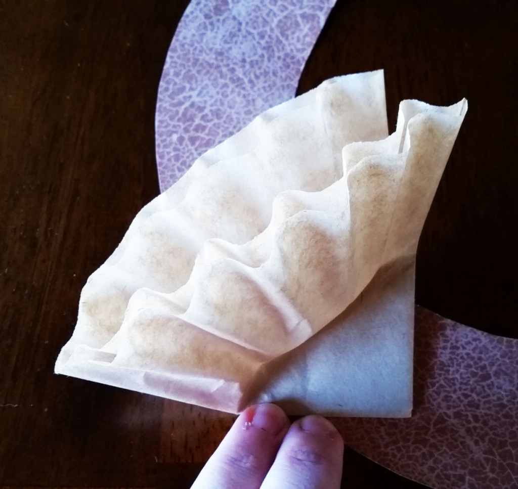 Folded coffee filter added to wreath